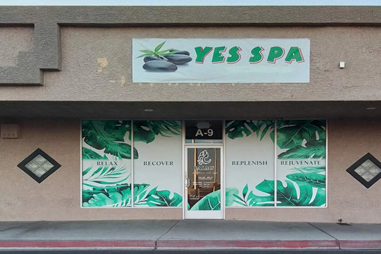 Yes SPA Las Vegas storefront on E Sahara Ave with green tropical leaf window graphics